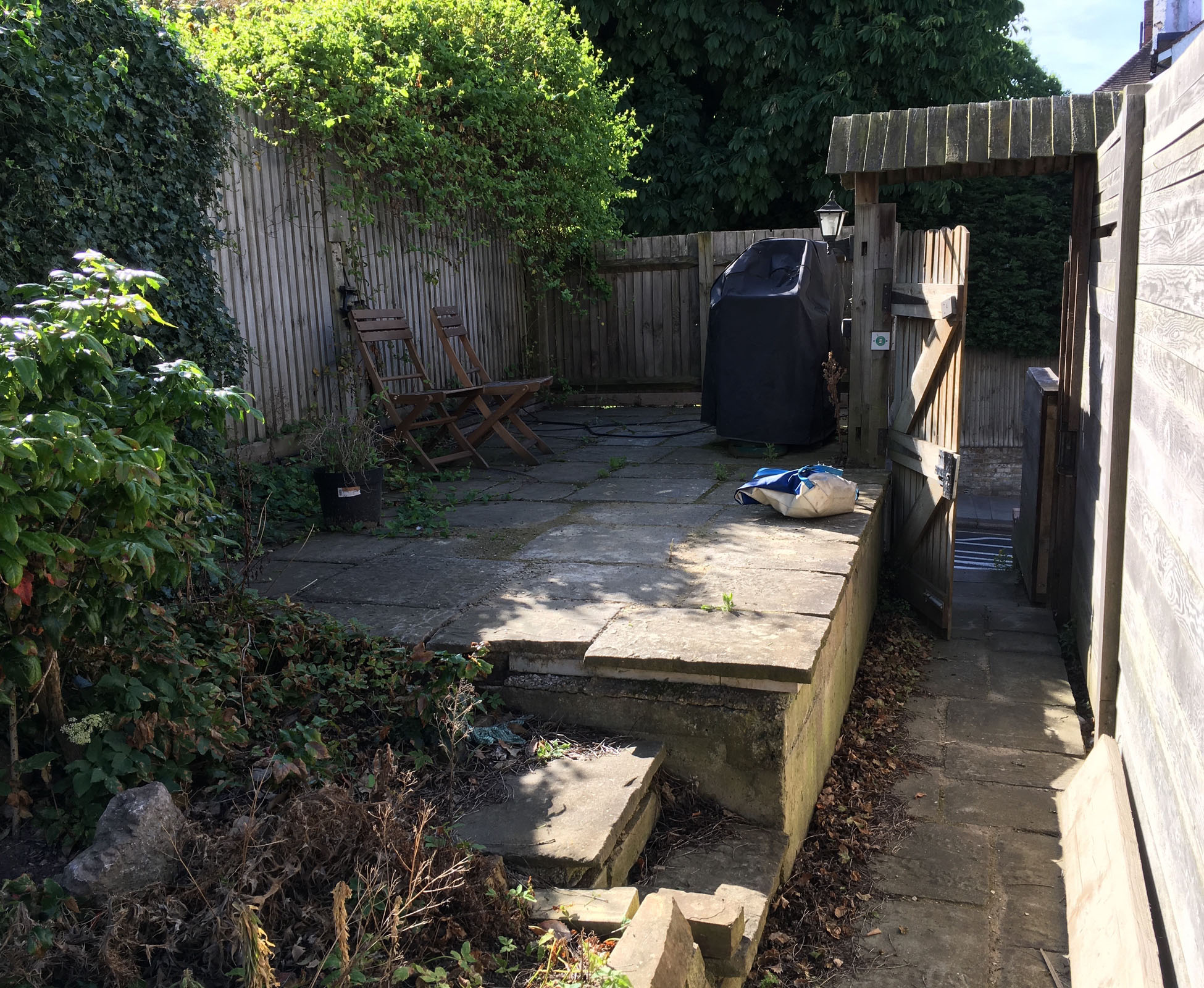 View of the garden in Bounds Green before the design and build started, you can see the paved garage roof that the new garden now sits above.