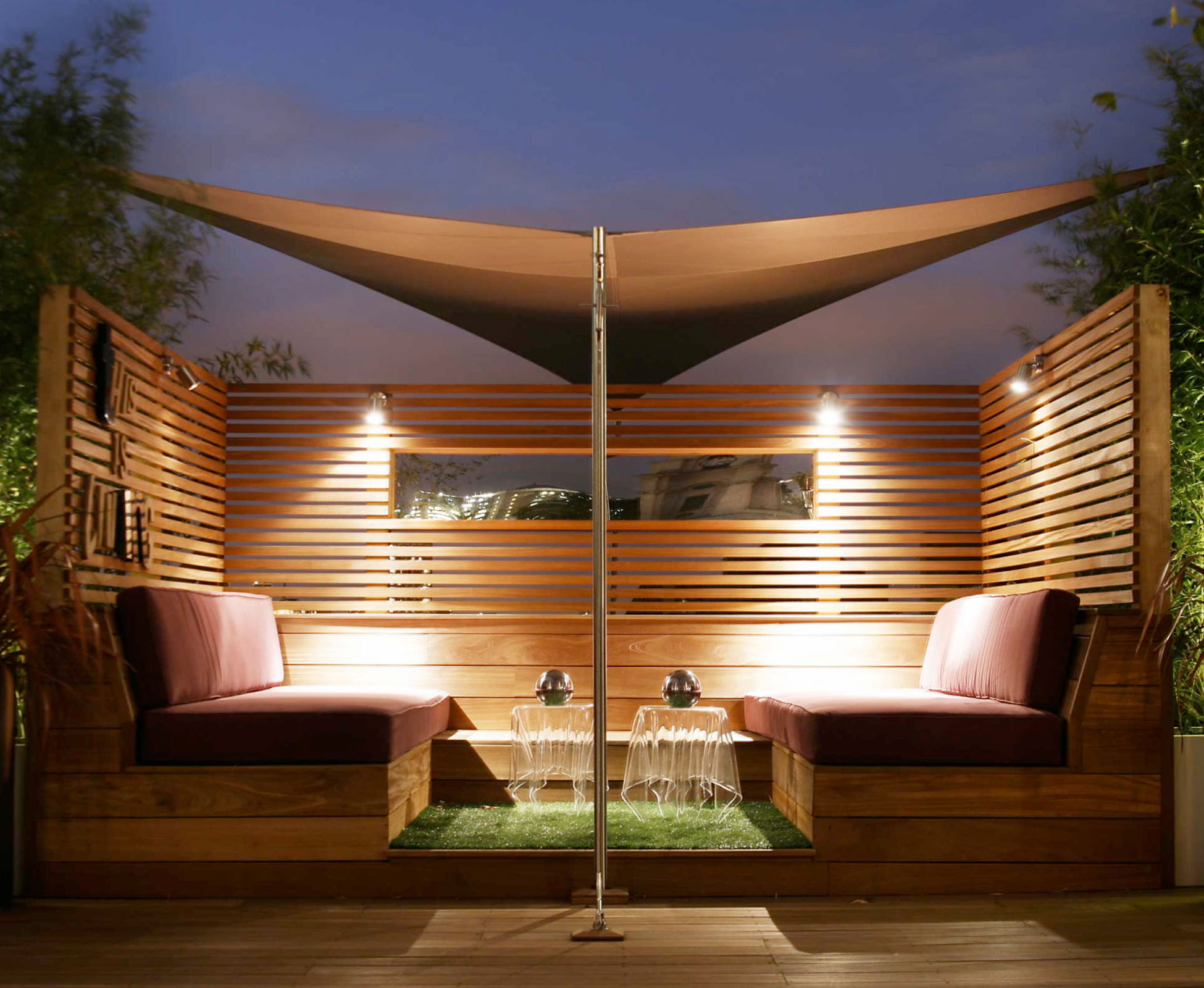 A hyperbolic shade sail sits above the built in seating, creating an intimate atmsosphere.