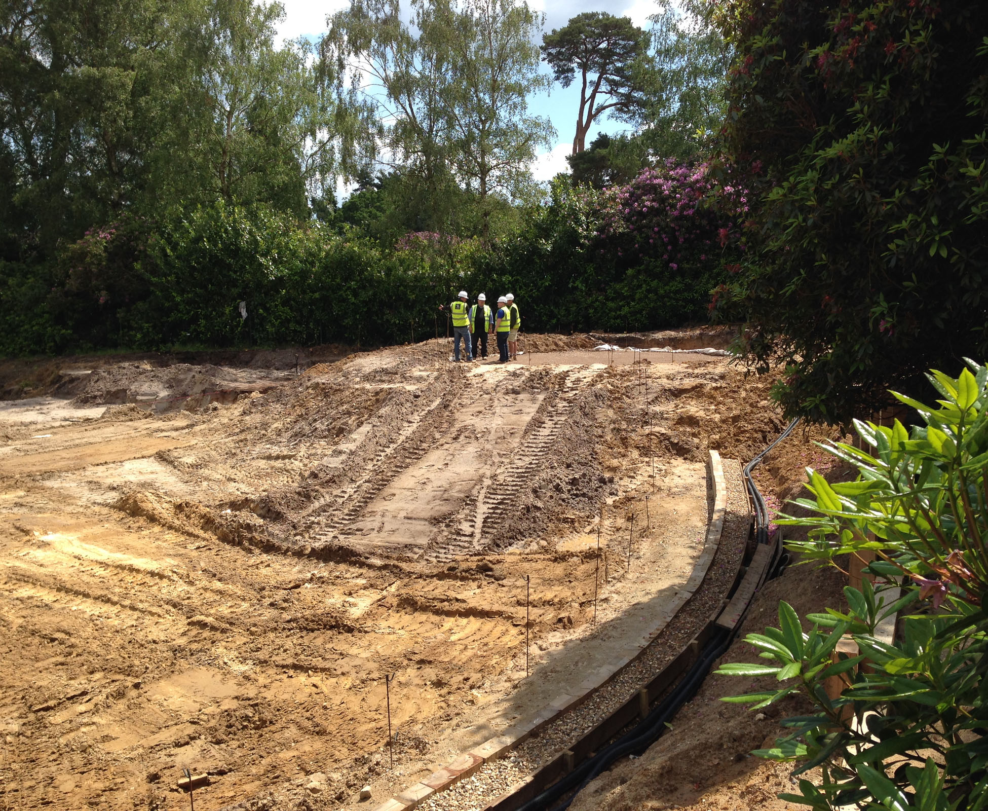 The country garden  before the landscaping work started. The groundworks are taking place whilst the house is built from a bare plot.