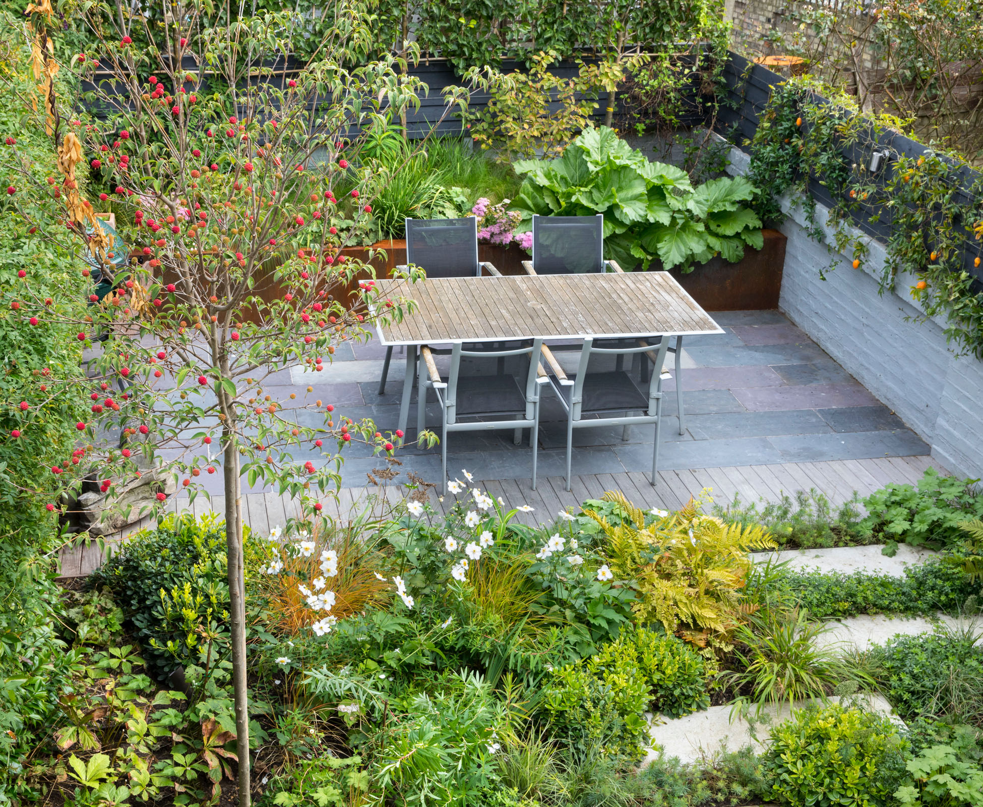 View from the top floor of this Crouch End garden, North London, showing the reclaimed slate patio with a hardwood ipe banding detail.
