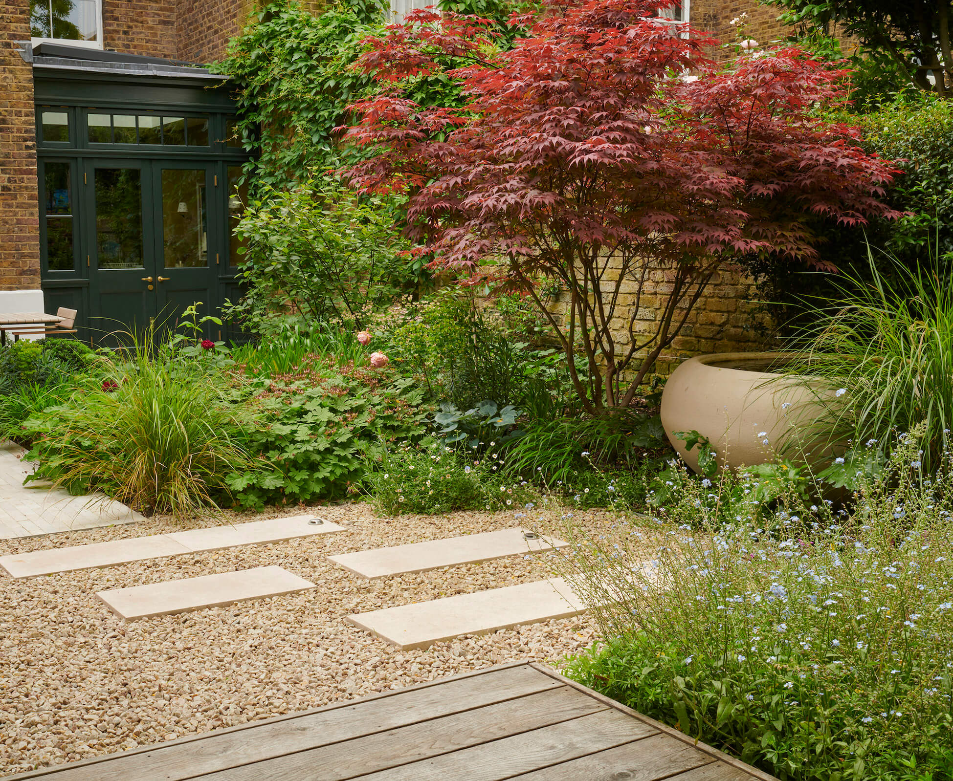 The Urbis poppy bowl provides a subtle focal point and water feature within this Highbury garden, beautifully offset by a Japanese acer. 