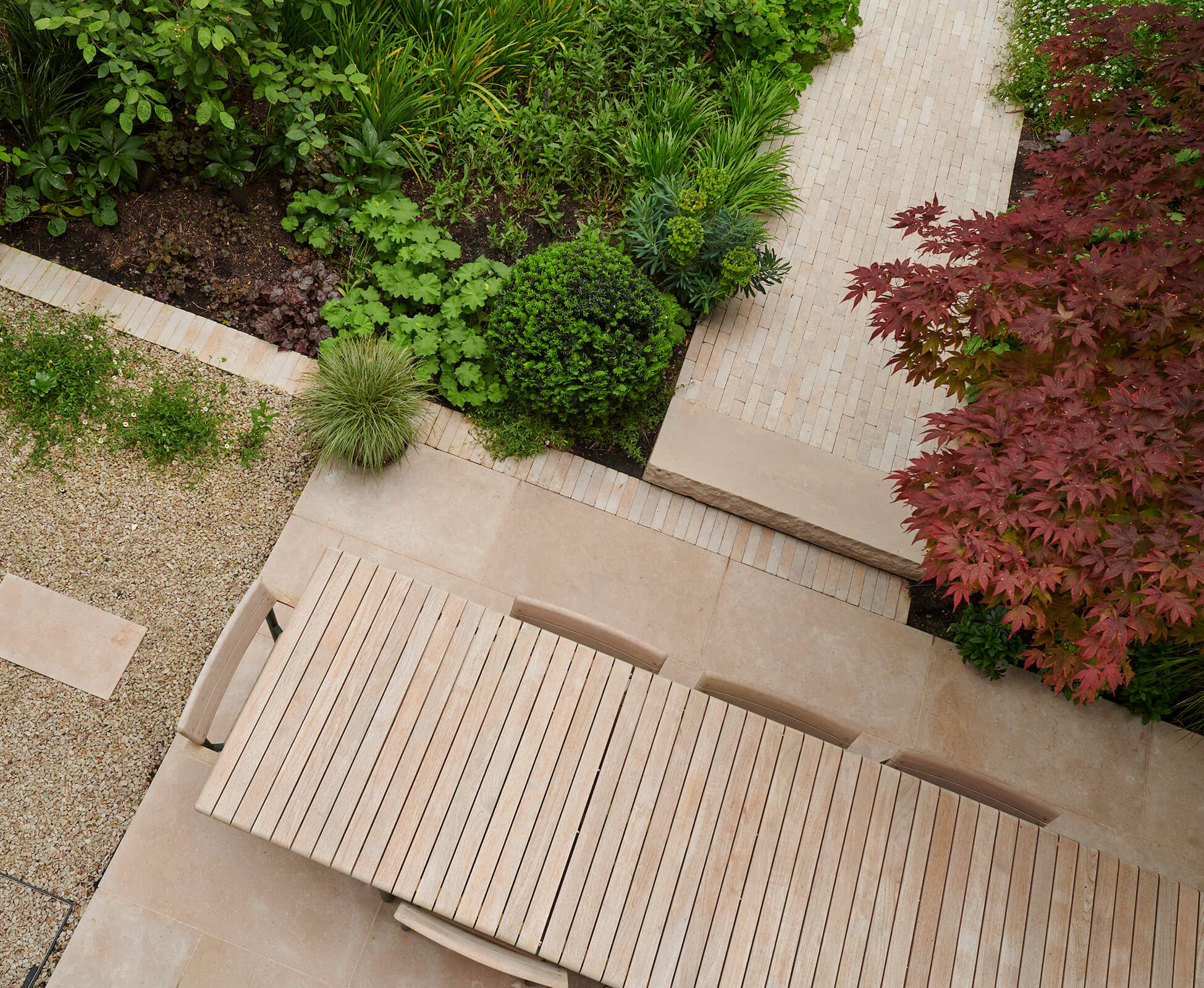 Our Highbury clients chose an attractive hardwood slatted outdoor dining table that perfectly compliments the soft natural tones of the hard landscaping.