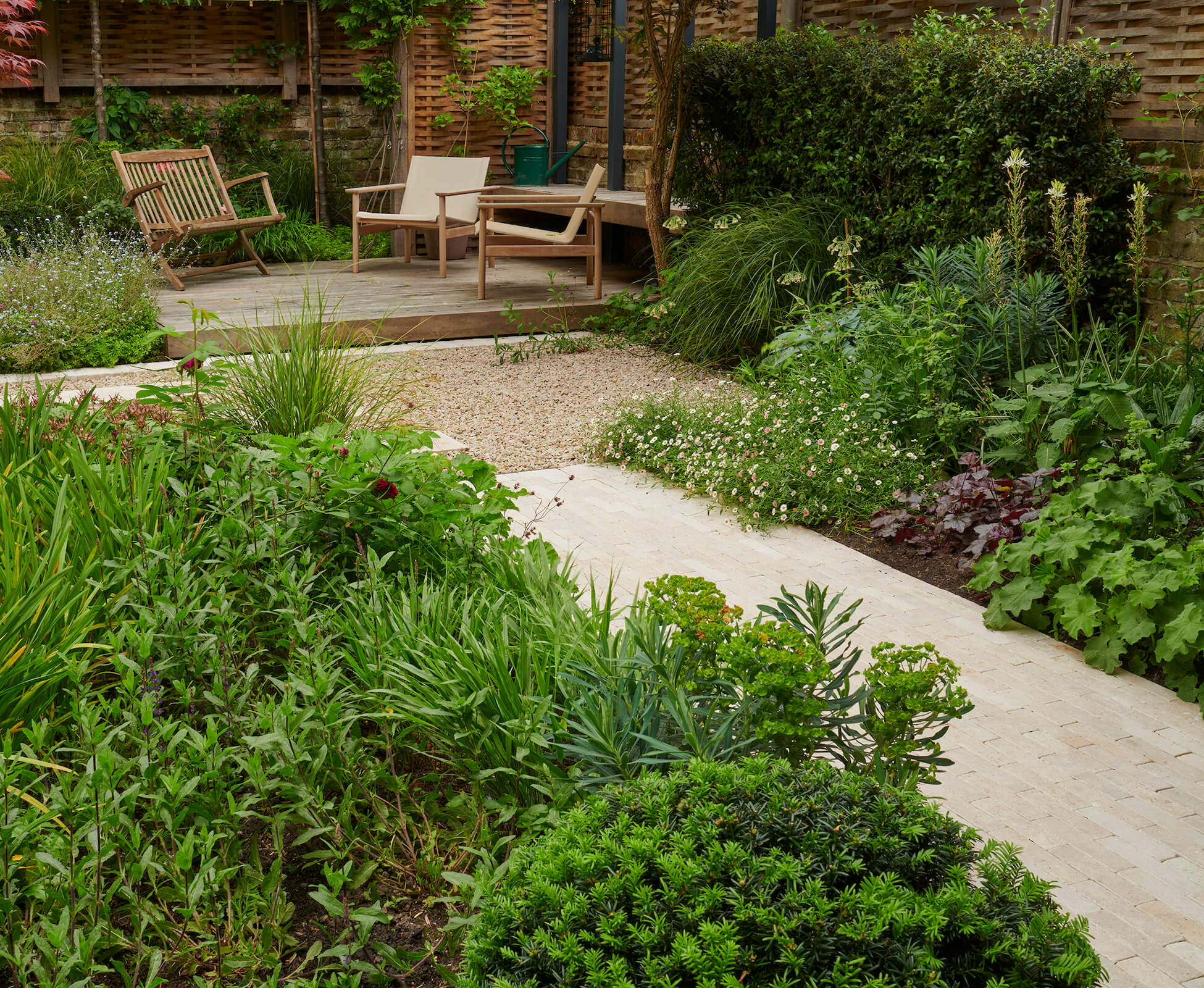 Naturalistic planting envelops the hard landscaping in this garden to create a green oasis in the heart of london.