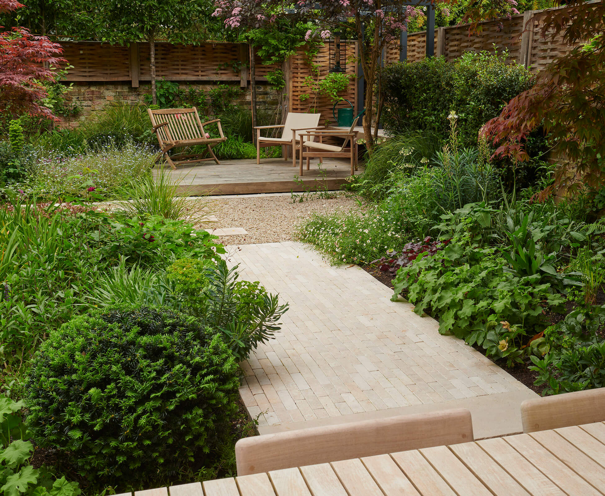 Quercus oak woven panels were used as boundary fencing on top of the existing brick wall, to provide attractive screening and a soft framework to the garden.