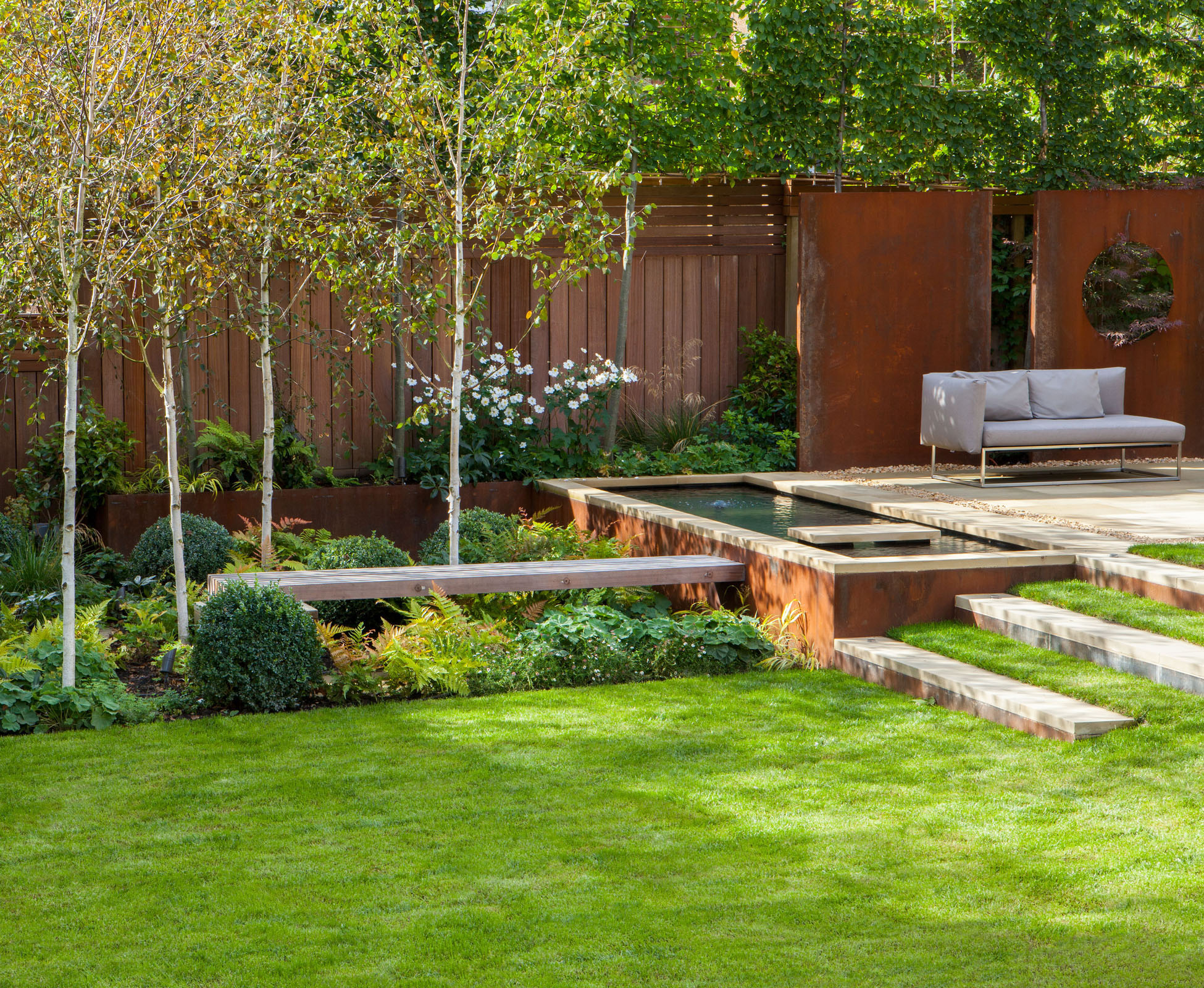 The water feature leads you across the timber bench, through the woodland copse of Birch trees to the outdoor studio