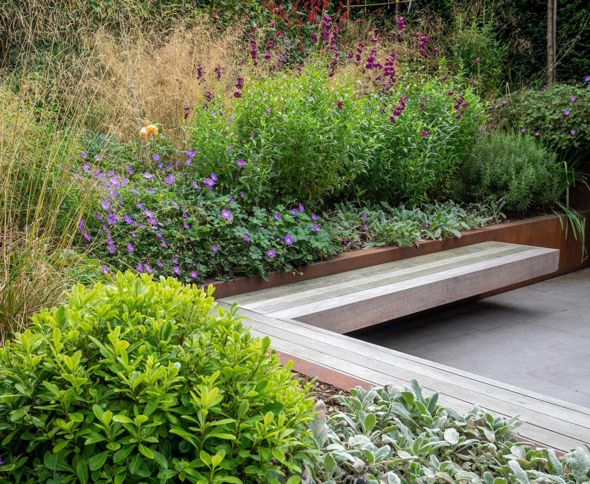 An L shaped floating hardwood timber bench