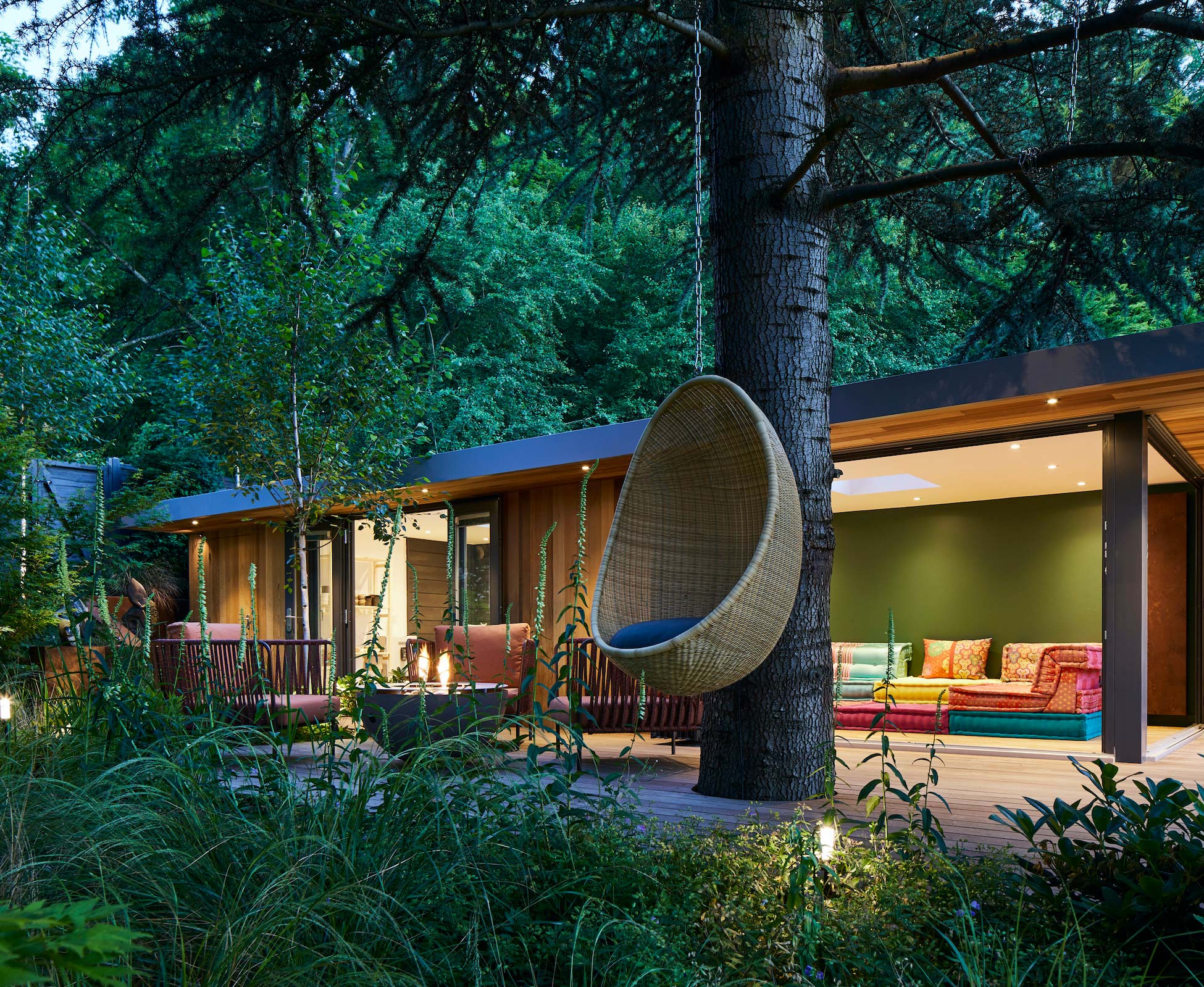 Nightime shot of the whole studio tucked and built around the clients beautiful Cedar tree.