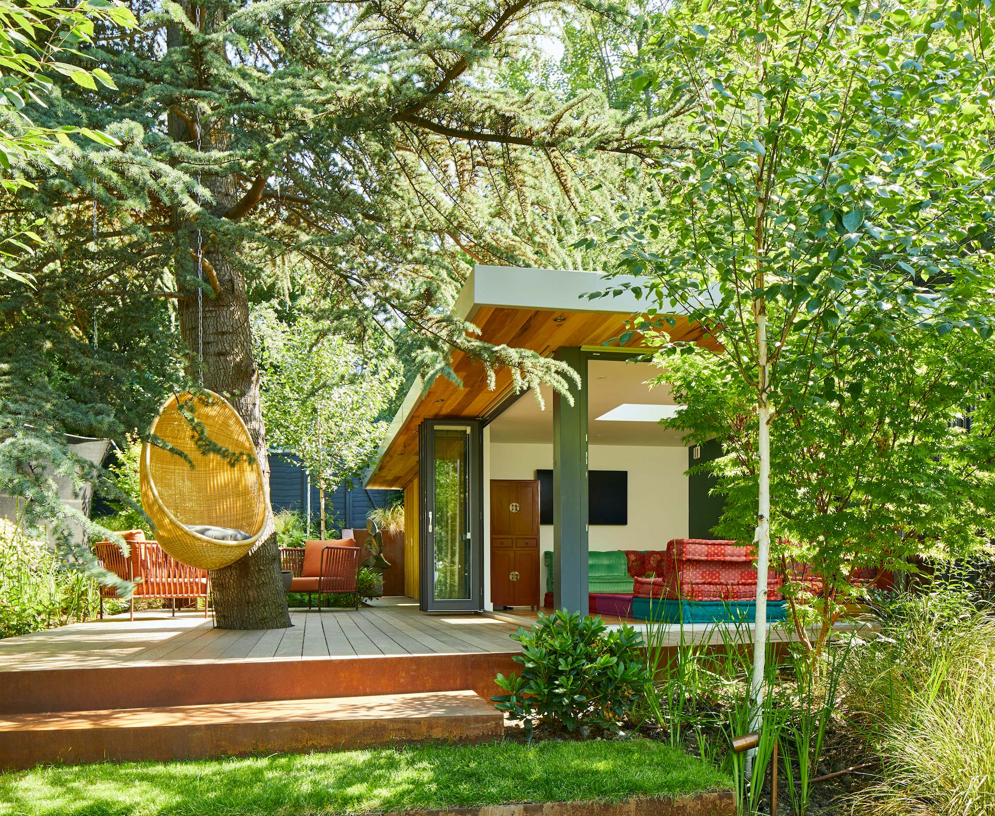 The clients woodland area to the rear of the garden with outdoor pottery studio and cosy lounge area with outdoor fire pit and armchairs for evening entertaining.