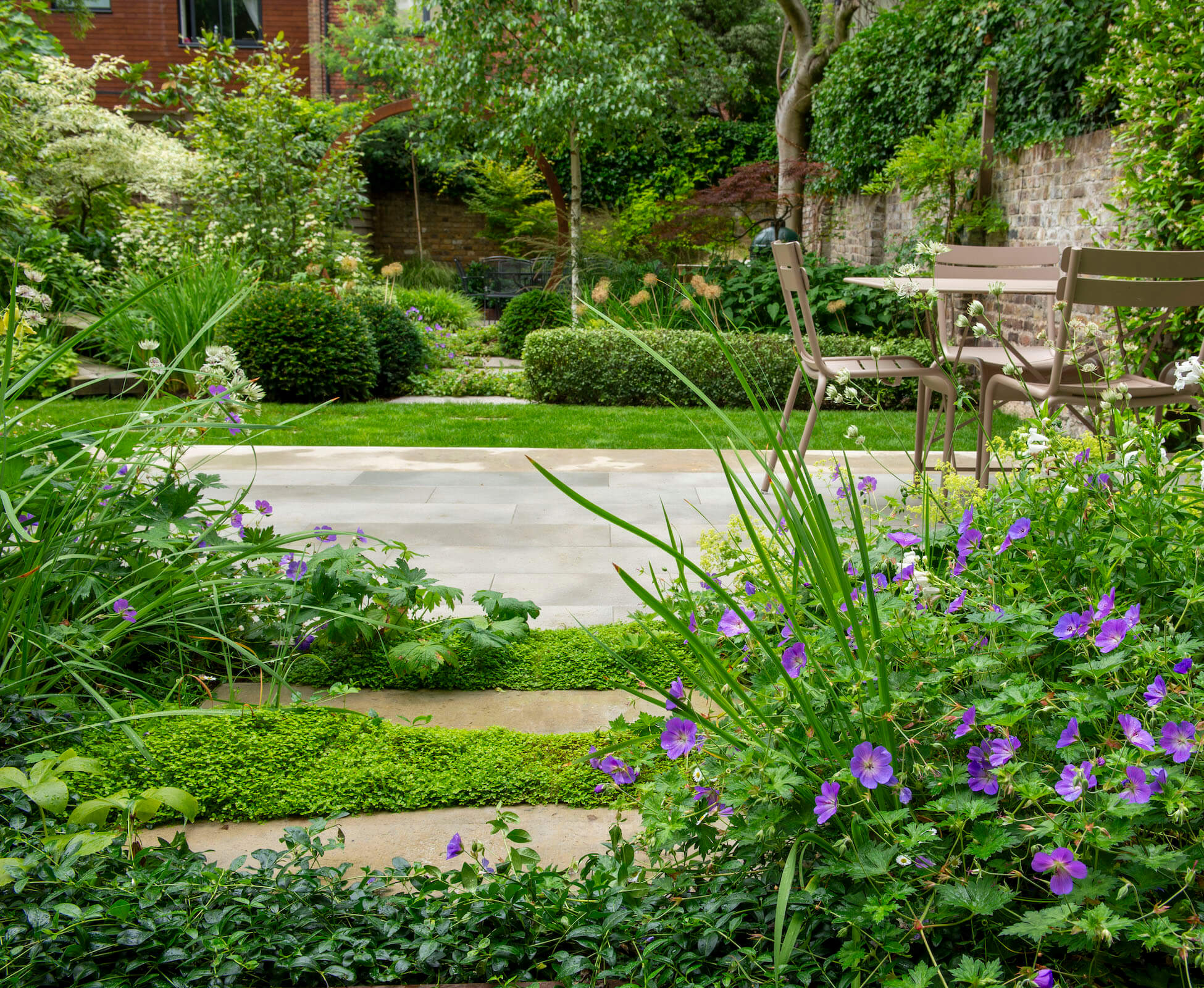 Generous seating areas are surrounded in lush planting, and provide opportunities to sit in sun or shade throughout the day.