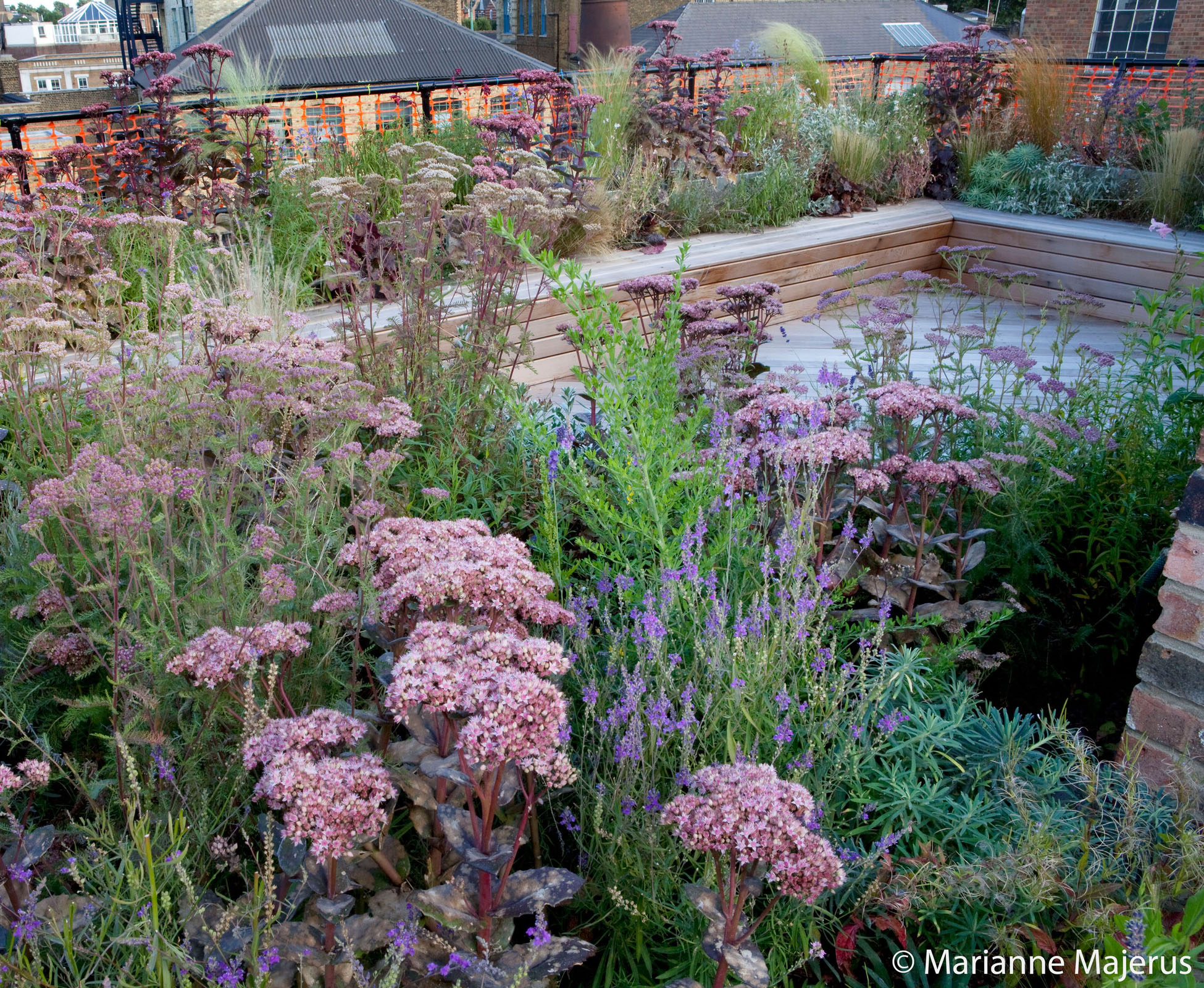 The bespoke built-in bench wraps around the red cedar timber decking to offer more possibilities and angles to enjoy the London skyline, both day and night.