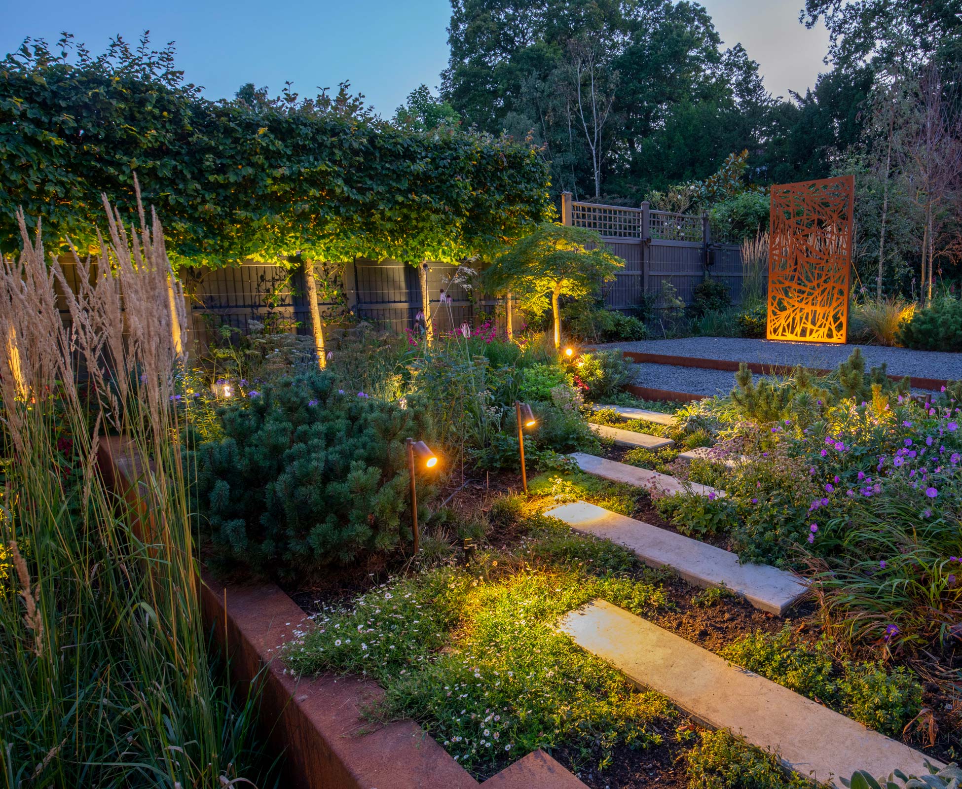 Stepping stones are lit up to ensure a safe and enchanting walk through the garden at night.