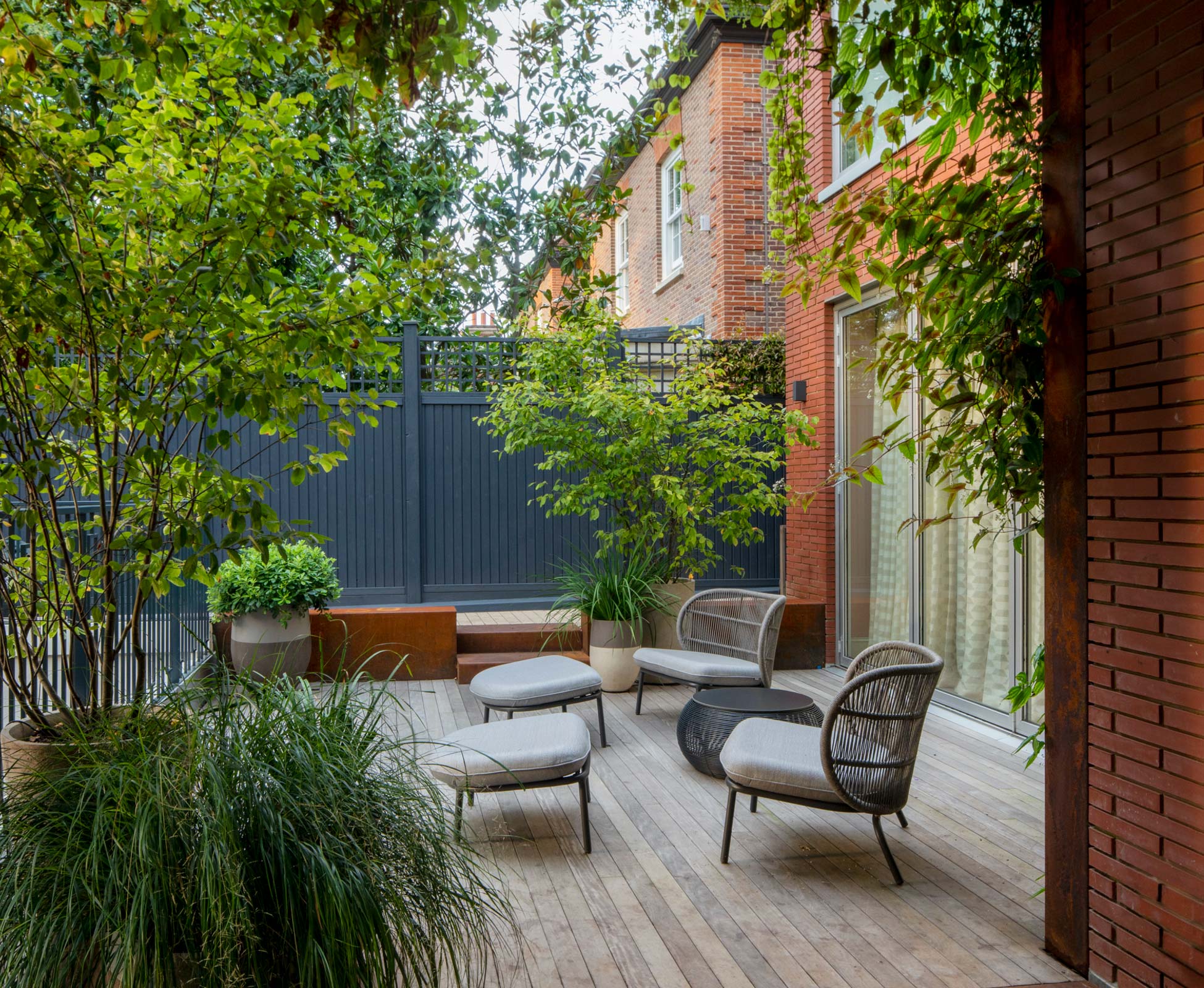A more private and sheltered seating spot on the ground floor where you can comfortably surrounded by a gorgeous selection of Atelier Vierkant pots, and the trailing plants from the living wall,