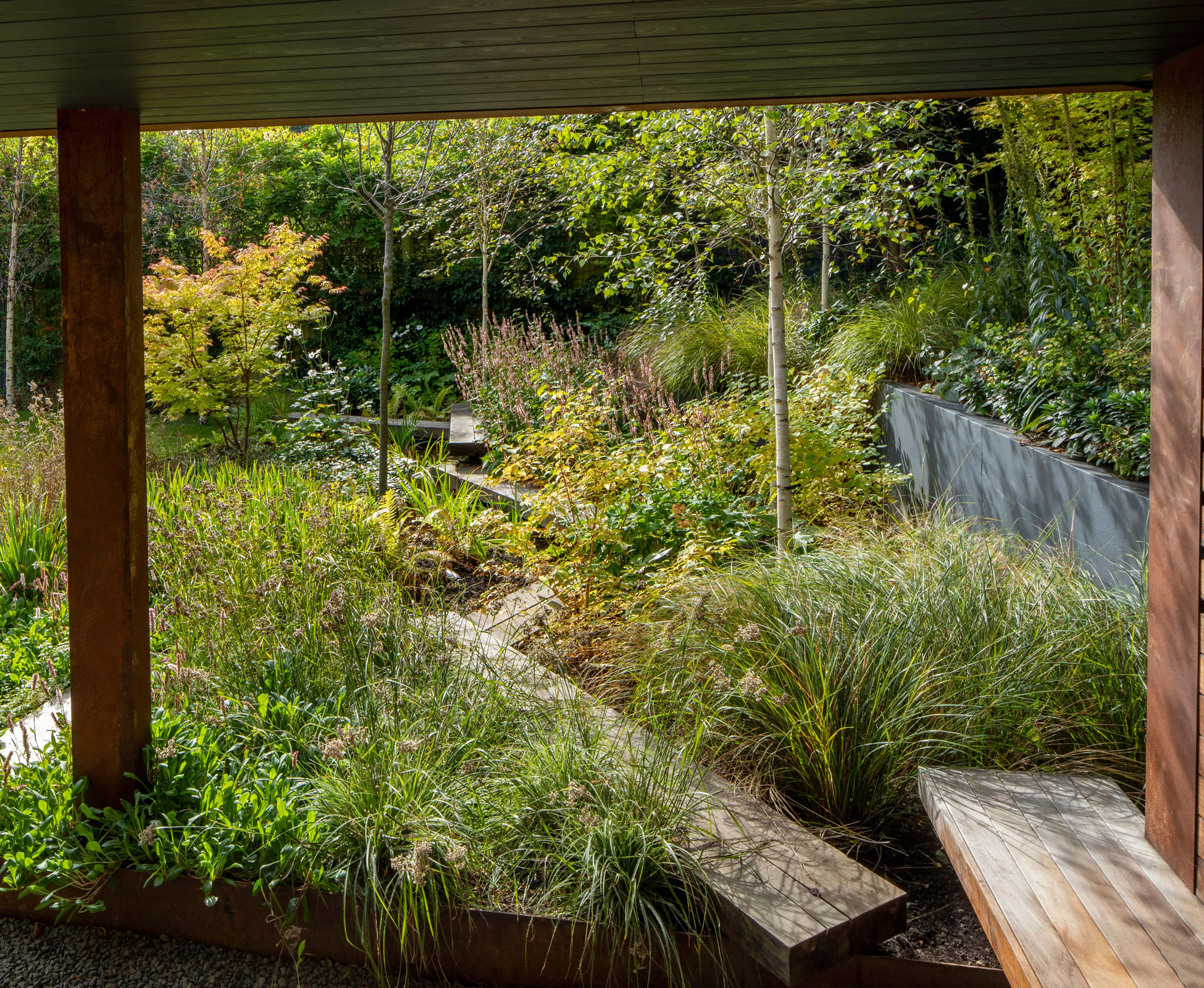 The rear boundary fence is strategically dark painted to ‘disappear’ among planting making the space visually bigger.