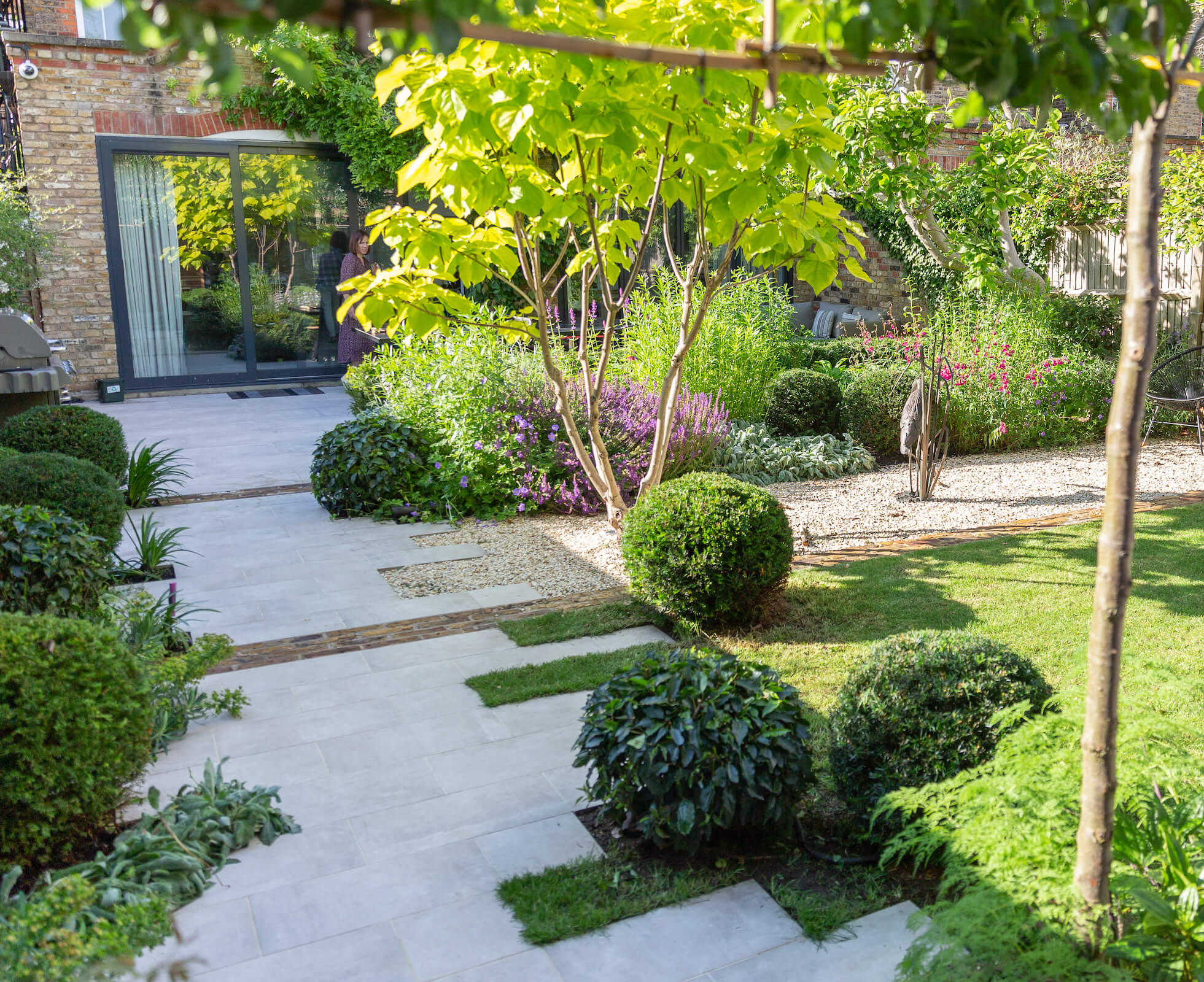 Staggered porcelain banding strips, are off set with reclaimed london stocks to create an interesting access path in this Tufnell Park garden.